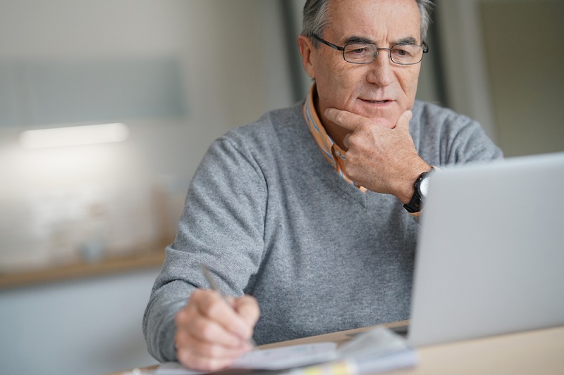 Senior man at home connected on laptop computer; Shutterstock ID 552964717; Purchase Order: 4018; Job: haemcare; Client/Licensee: NovoNordisk Germany; Other: 