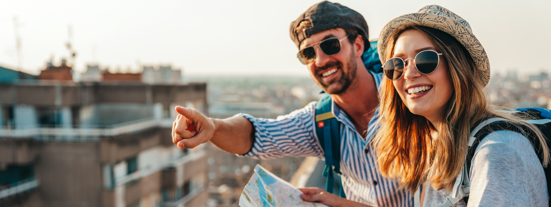 Happy tourists couple, friends sightseeing city with map together. Travel people fun concept.